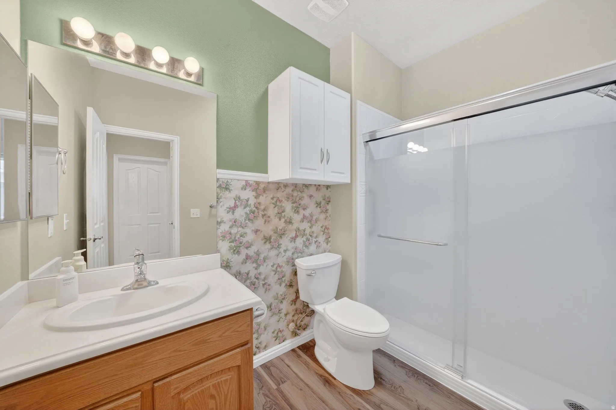 Bathroom featuring a single vanity with wood-finish cabinetry and a white countertop