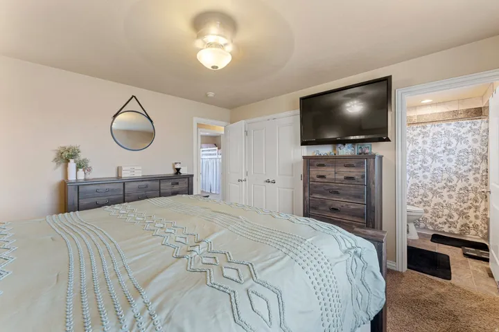 Bedroom featuring a semi-flush mount ceiling light, neutral wall colors, and carpet flooring