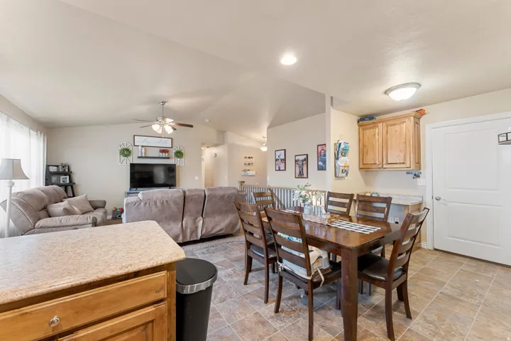 Open-concept living space featuring wood-finish flooring, vaulted ceilings, and recessed lighting