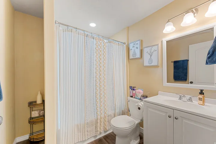 Bathroom featuring a white vanity with integrated sink, chrome faucet, and white cabinetry