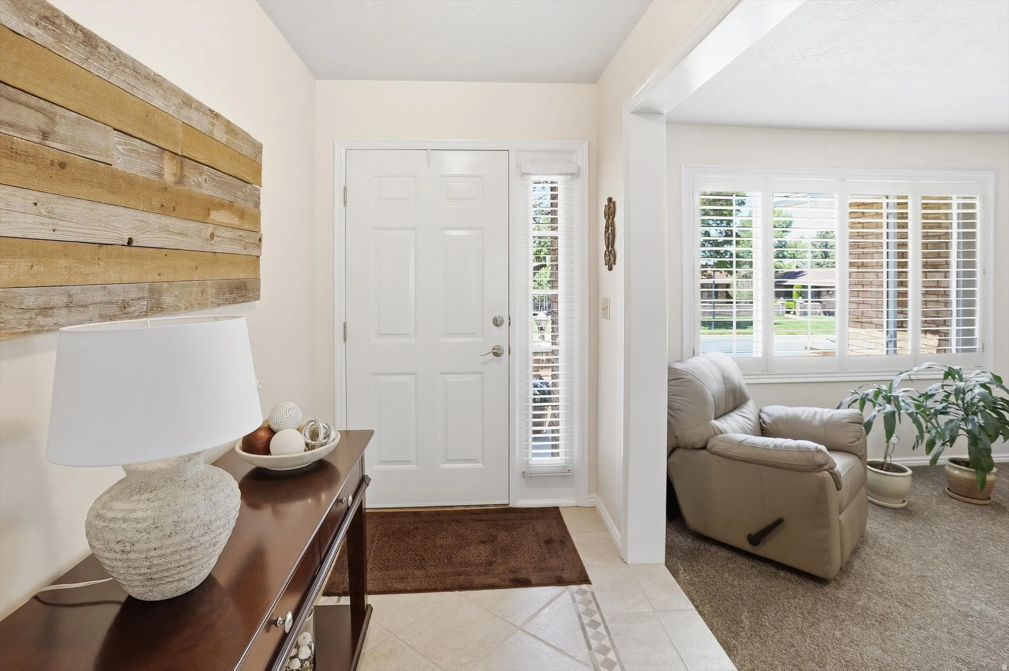 Entryway featuring a paneled door with sidelight, tile flooring, and light-toned walls