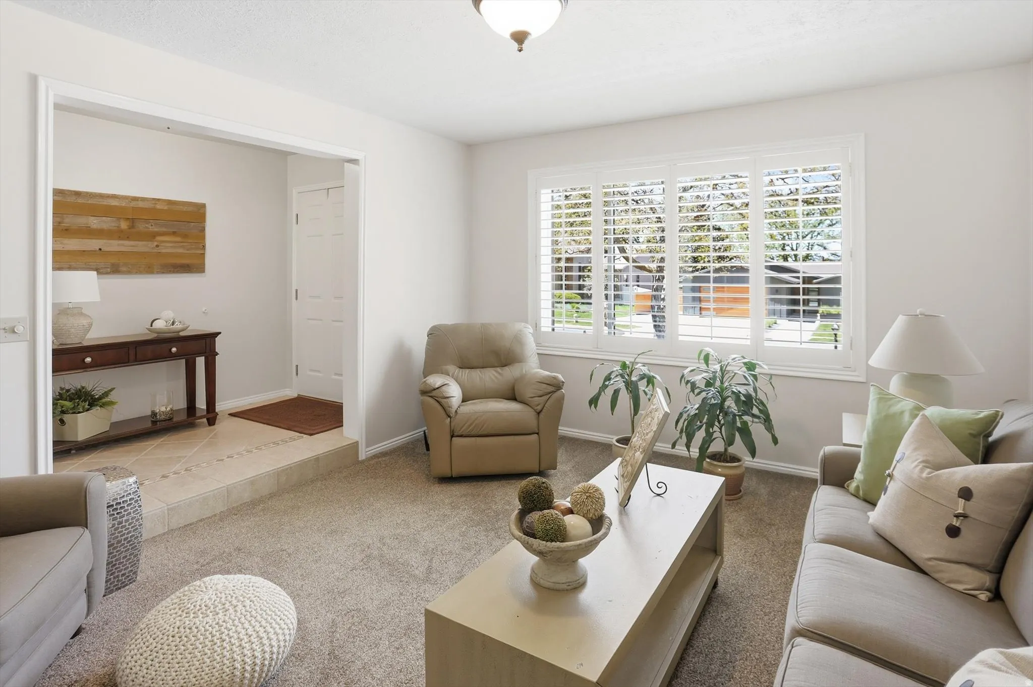 Living area featuring light-colored carpet flooring and white walls