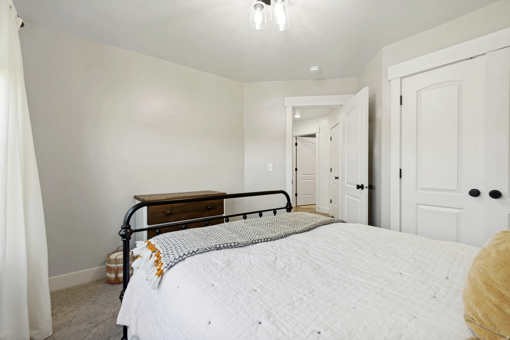 Bedroom featuring light gray wall paint, white trim, and light gray carpet flooring.