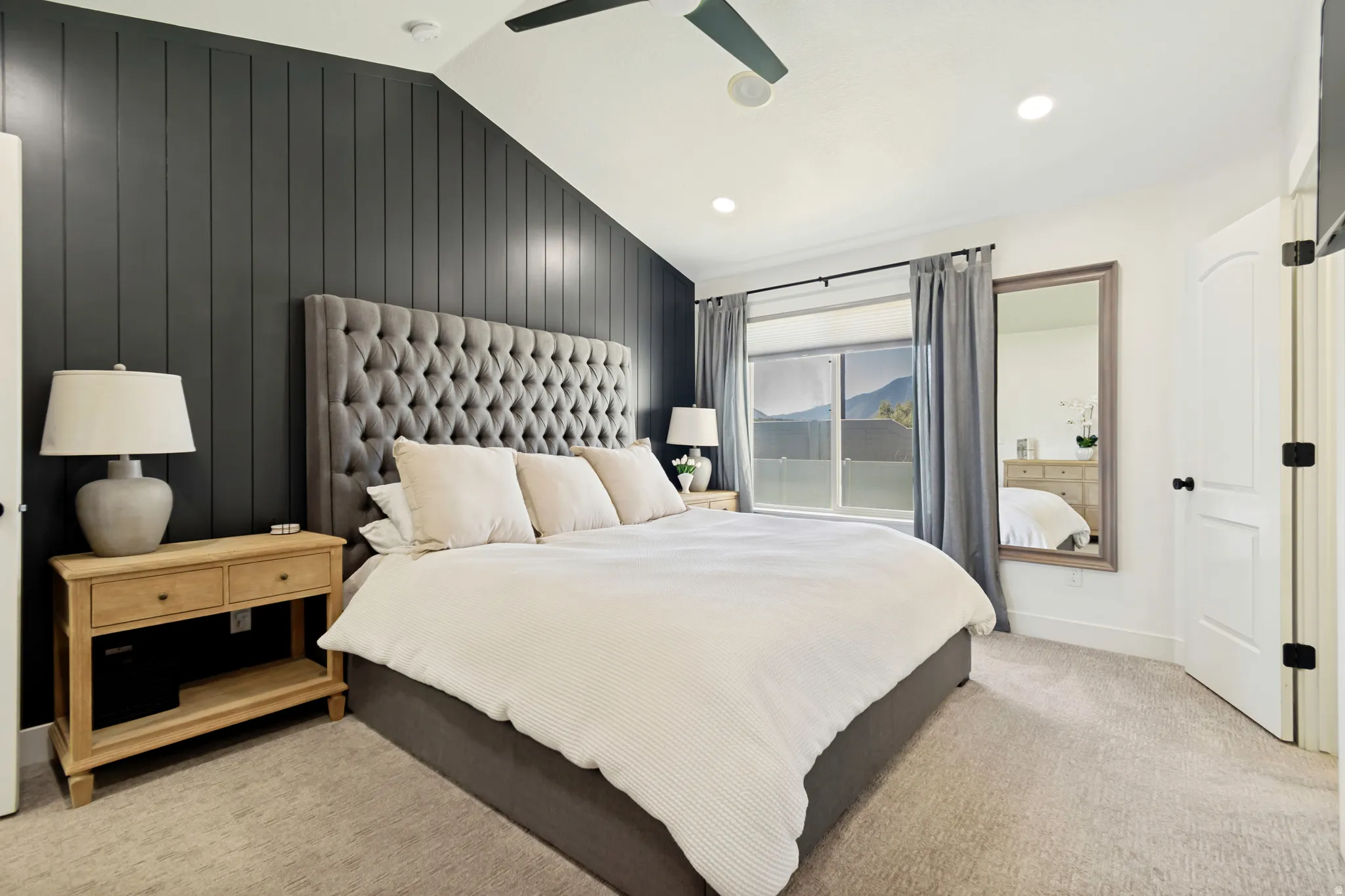 Vaulted ceiling bedroom featuring a dark shiplap accent wall, recessed lighting, ceiling fan, and carpeted flooring.