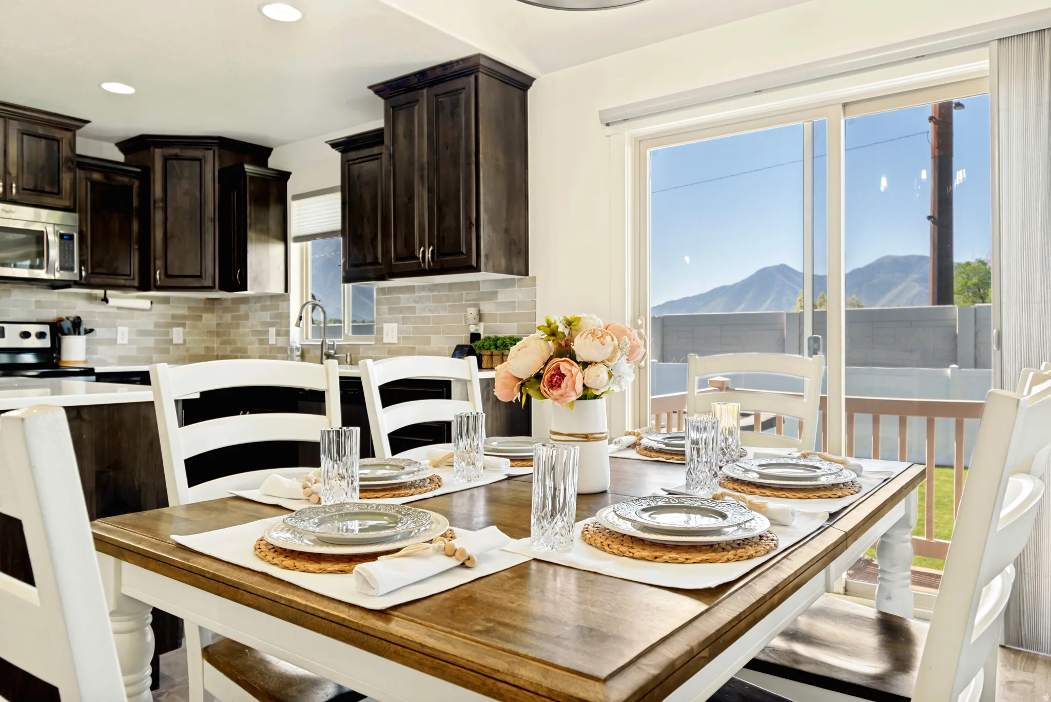 Dining area with wood-finish flooring and a sliding glass door.
