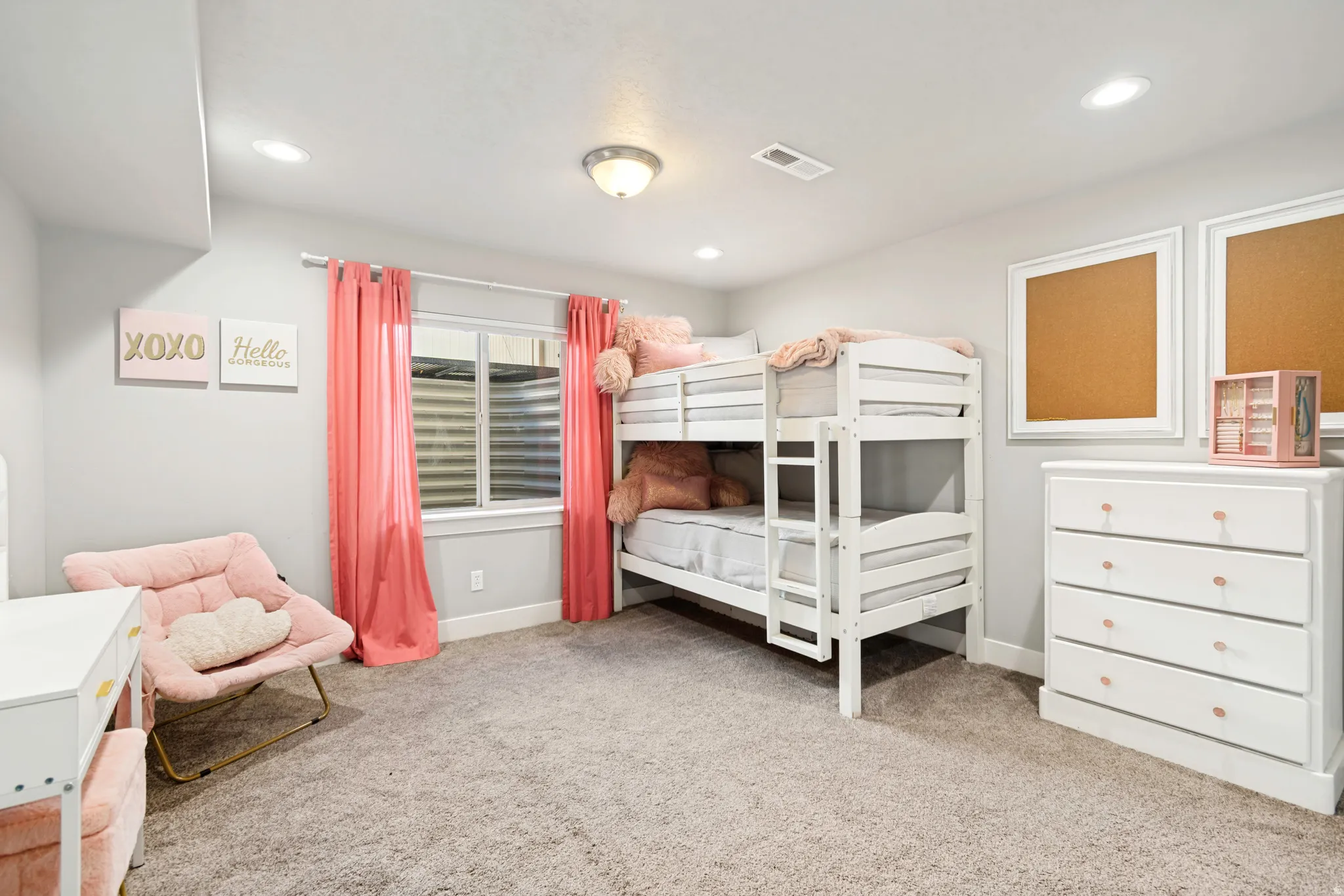 Large bedroom with carpeted flooring, and two tone paint.