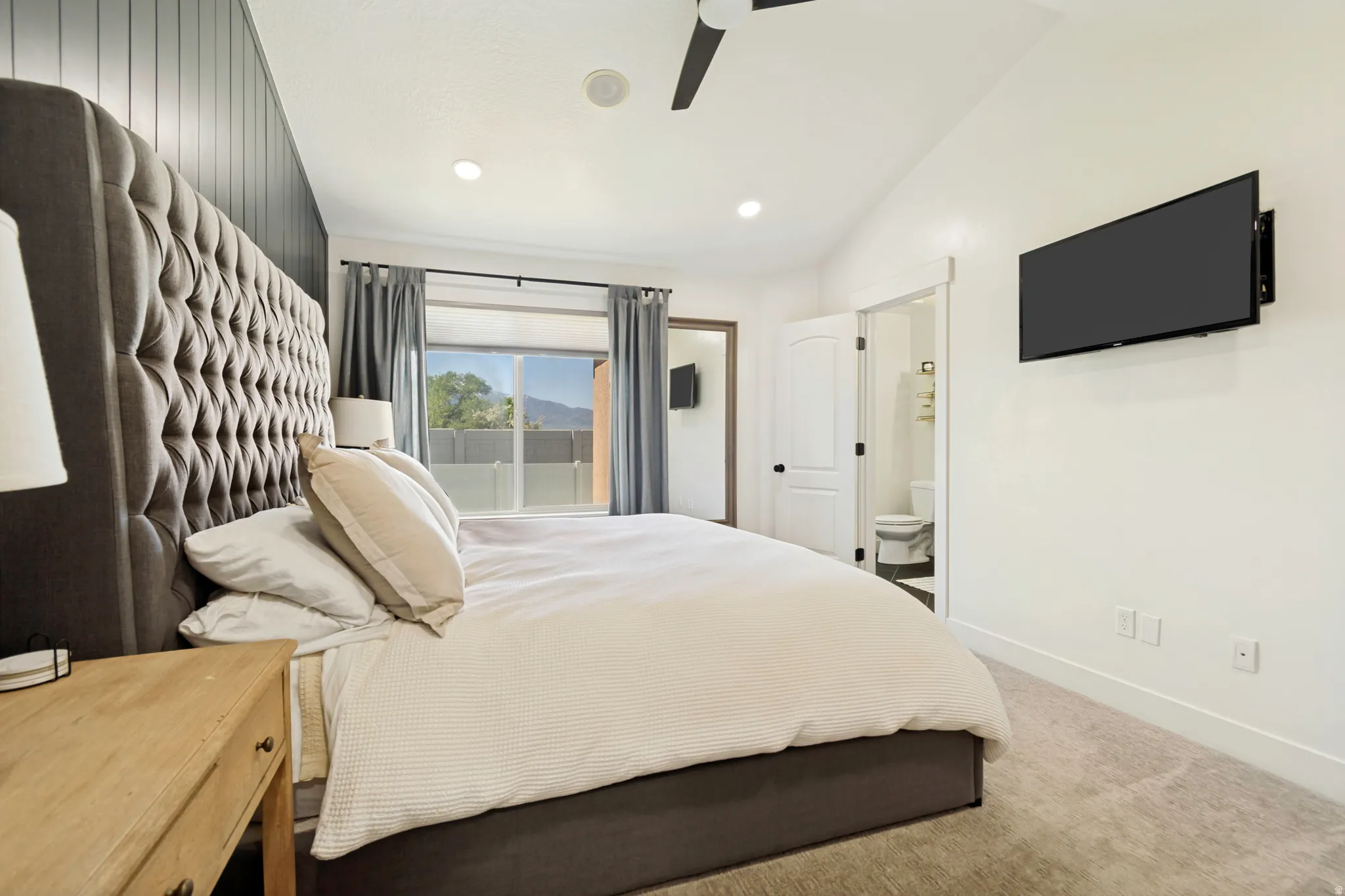 Bedroom with vaulted ceiling, recessed lighting, and a large window with excellent natural light.