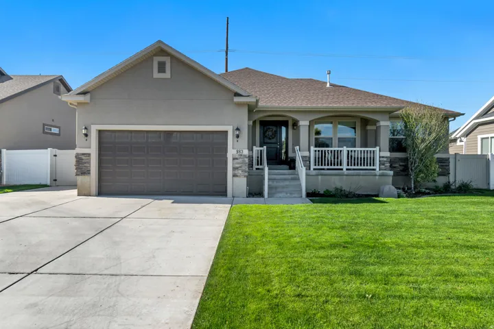 Beautiful Ranch-style home with a covered front porch, stone accents, a two-car garage, and an RV pad.