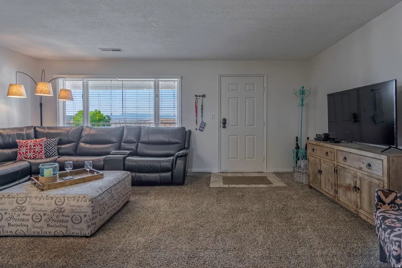 Living area with neutral tone carpeting and white walls