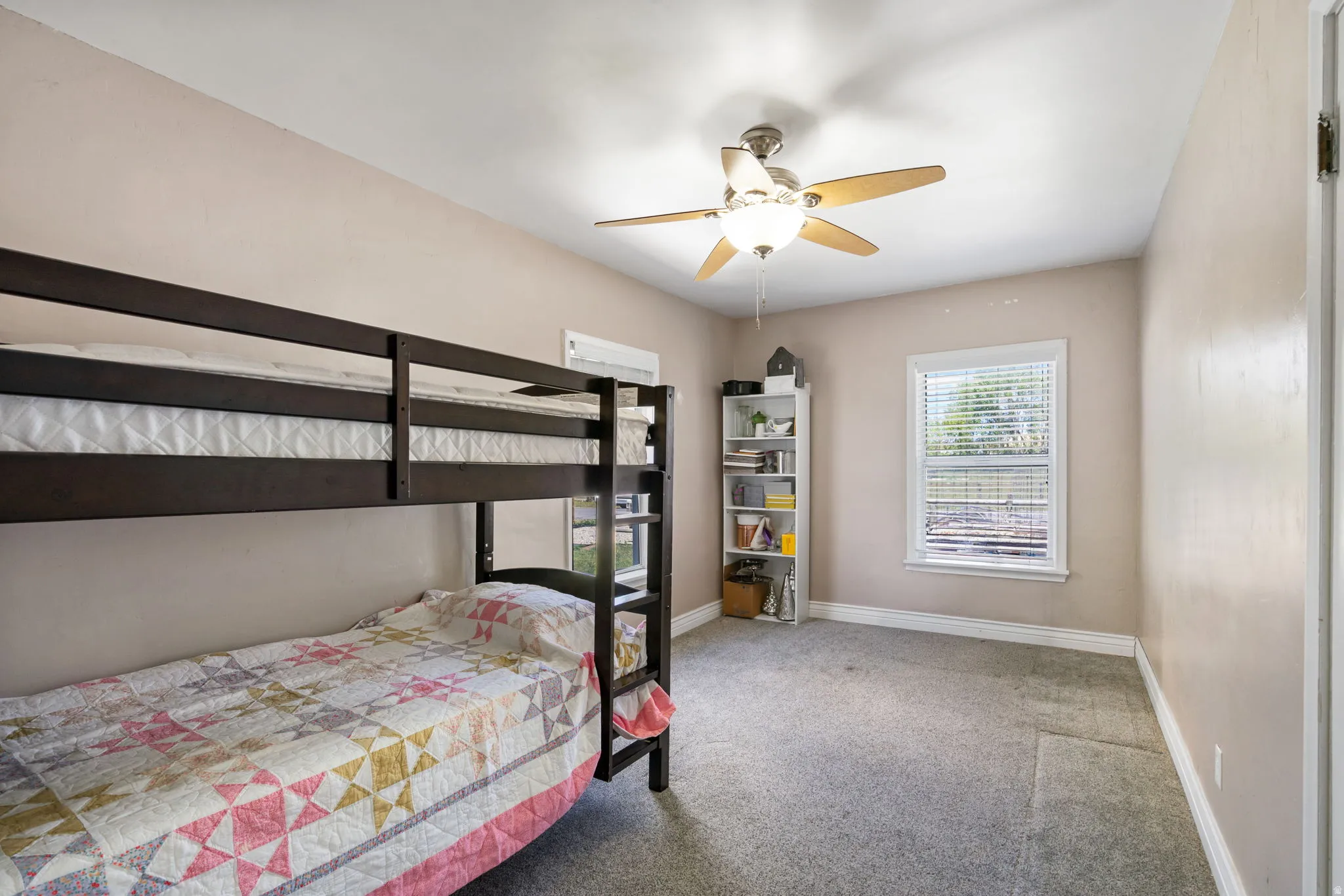 Room with neutral wall paint and gray carpet flooring