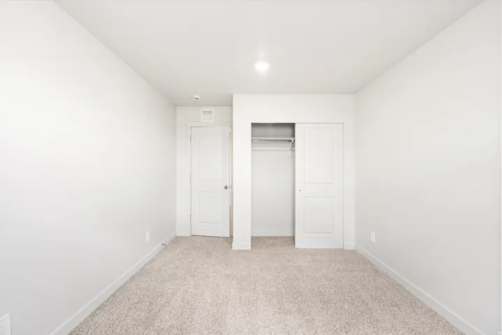 Neutral-toned carpeting complements the light wall color