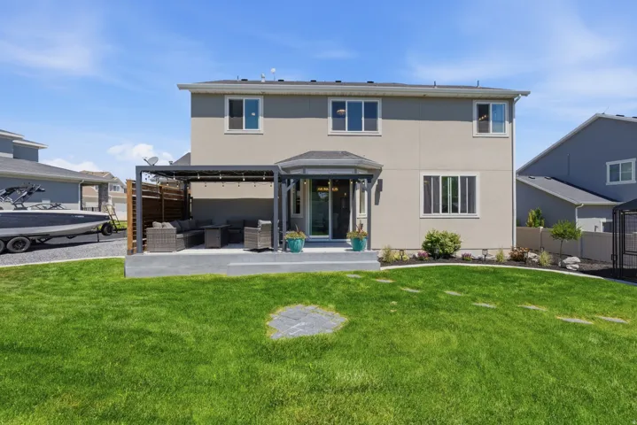 Expansive green lawn with stepping stones, bordered by landscaped garden beds