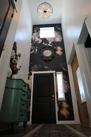Soaring entryway with a decorative accent wall and high ceilings