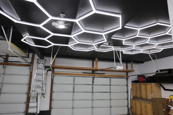 Garage interior featuring a black ceiling with hexagonal LED lighting fixtures