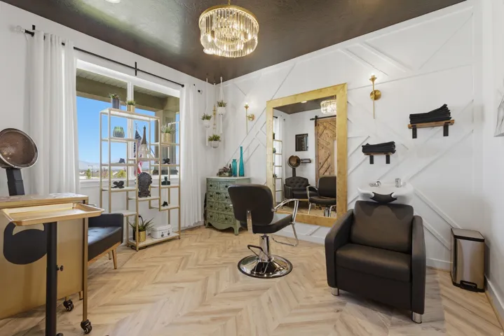 Herringbone wood-finish flooring with a dark ceiling and white paneled walls