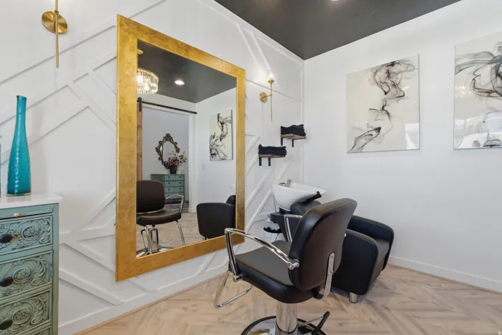 Accent wall with geometric trim, light wood-finish herringbone flooring, and a contrasting dark ceiling