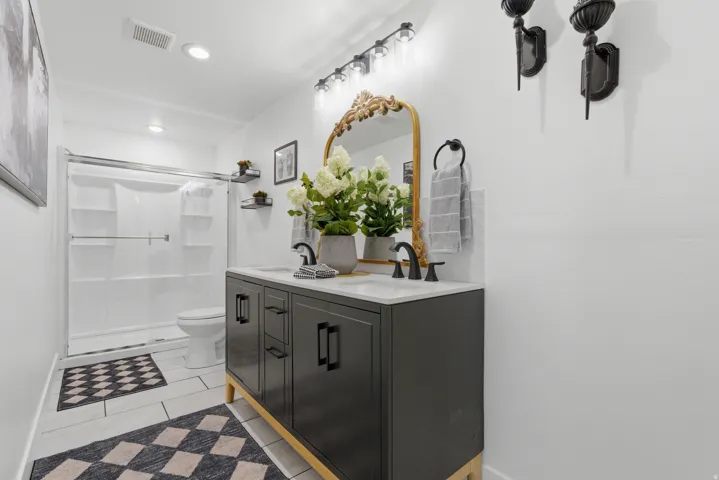 Double vanity with a white countertop and matte black fixtures