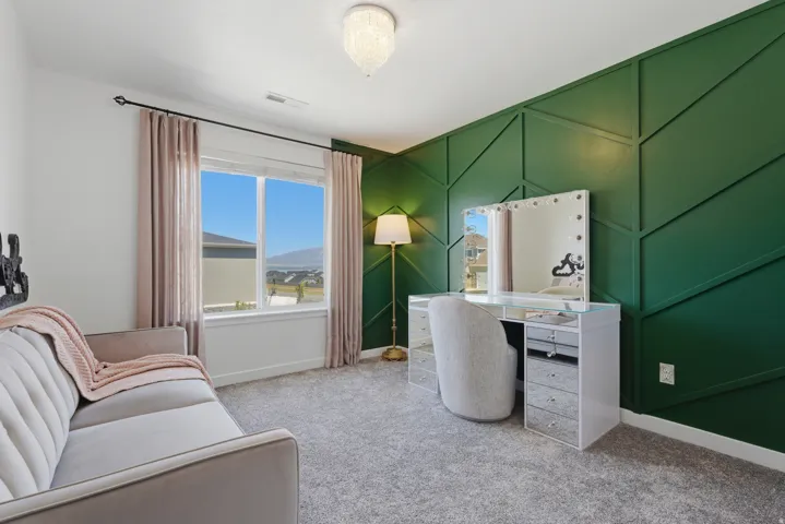 Geometric accent wall featuring a deep green finish
