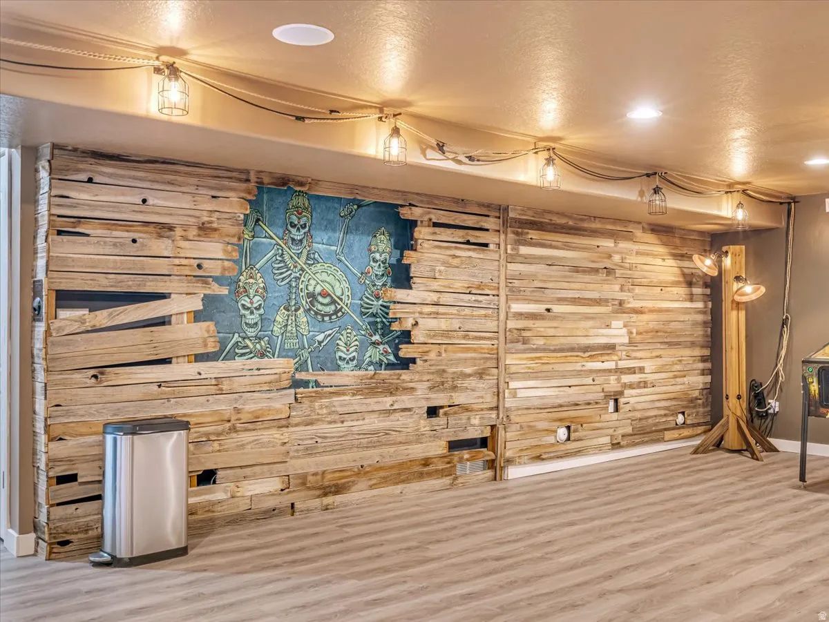 Accent wall featuring reclaimed wood paneling and integrated mural