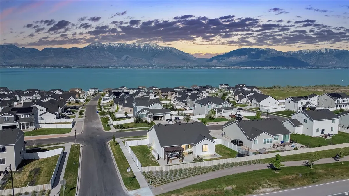 Residential neighborhood with a body of water and snow-capped mountains in the background