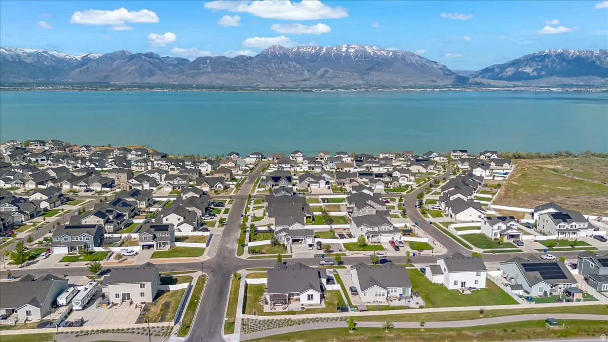 Residential community featuring a variety of single-family homes with dark roofs and light-colored exteriors