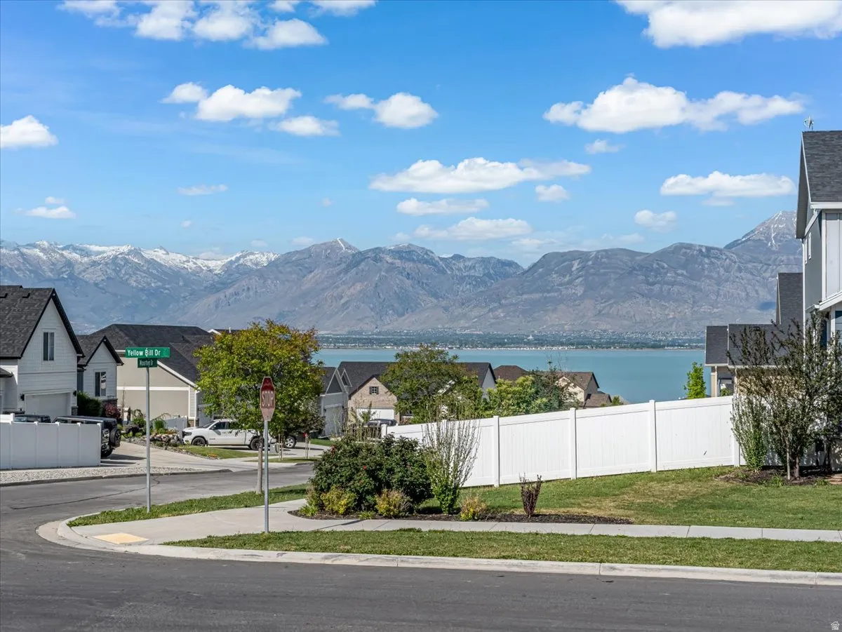 Snow-capped mountain range backdrop with a large body of water