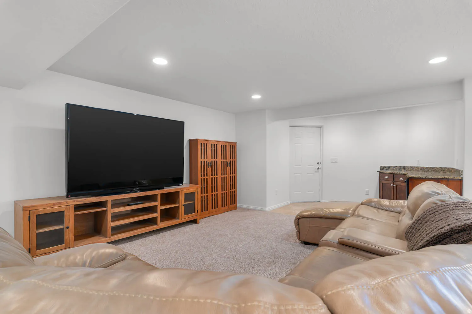 Spacious recreation room featuring recessed lighting and wall-to-wall carpeting