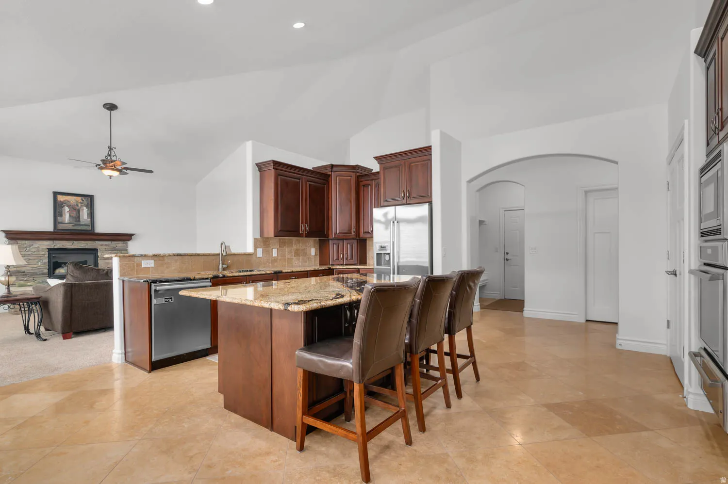Kitchen featuring a center island, granite countertops, wood cabinetry, and stainless steel appliances