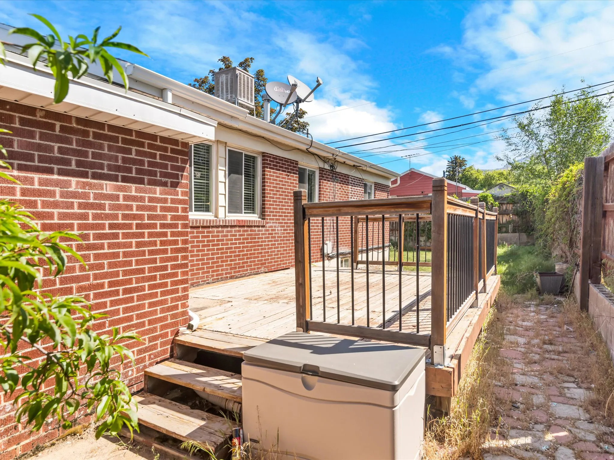 Outdoor wood deck featuring a black metal railing