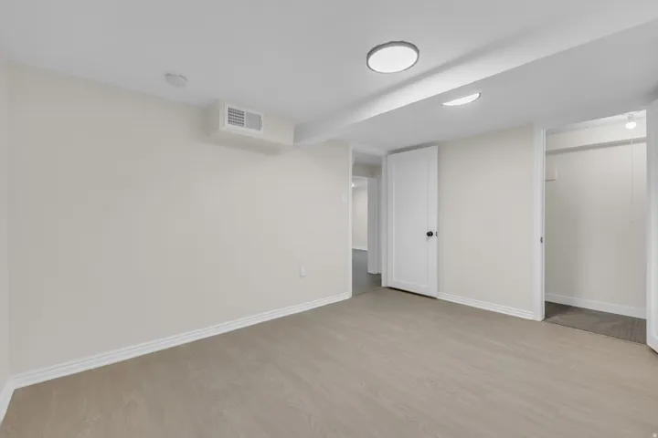 Neutral-toned walls complement the wood-finish flooring