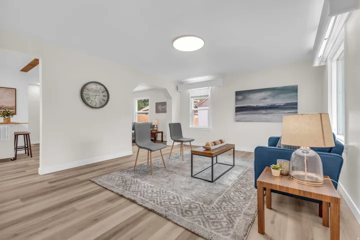 Open concept living area featuring wood-finish flooring, recessed lighting, and ample natural light from multiple windows
