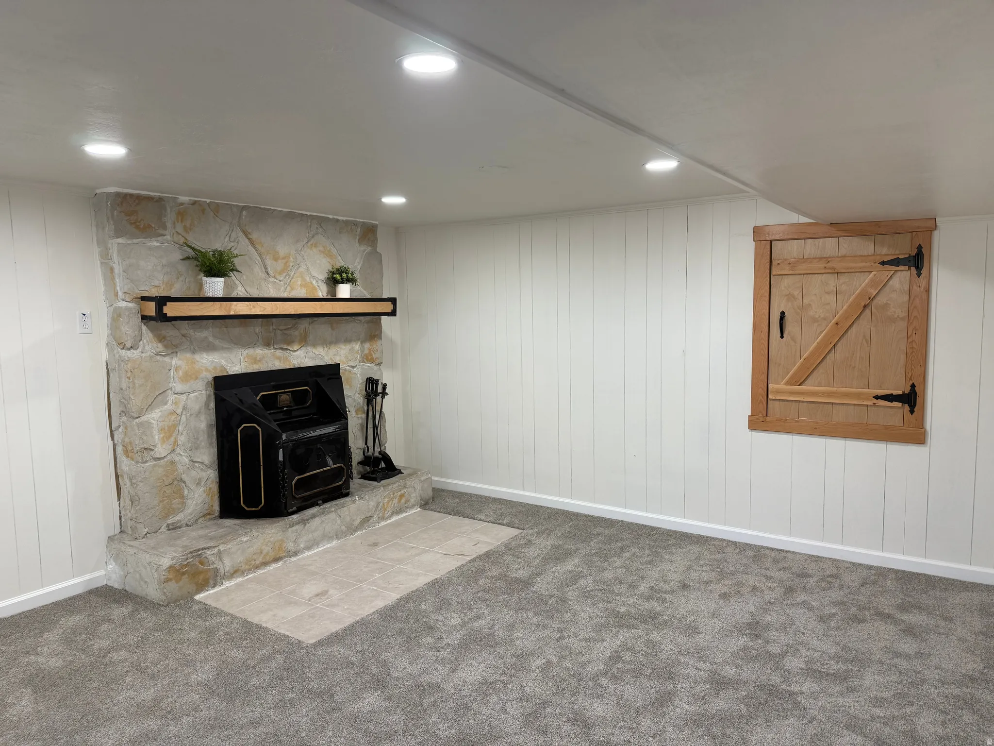 Stone fireplace with an integrated wooden mantel