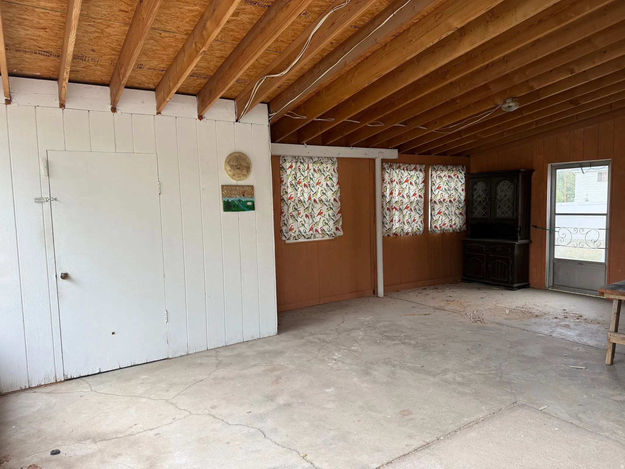 Exposed wood beam ceiling over a concrete floor