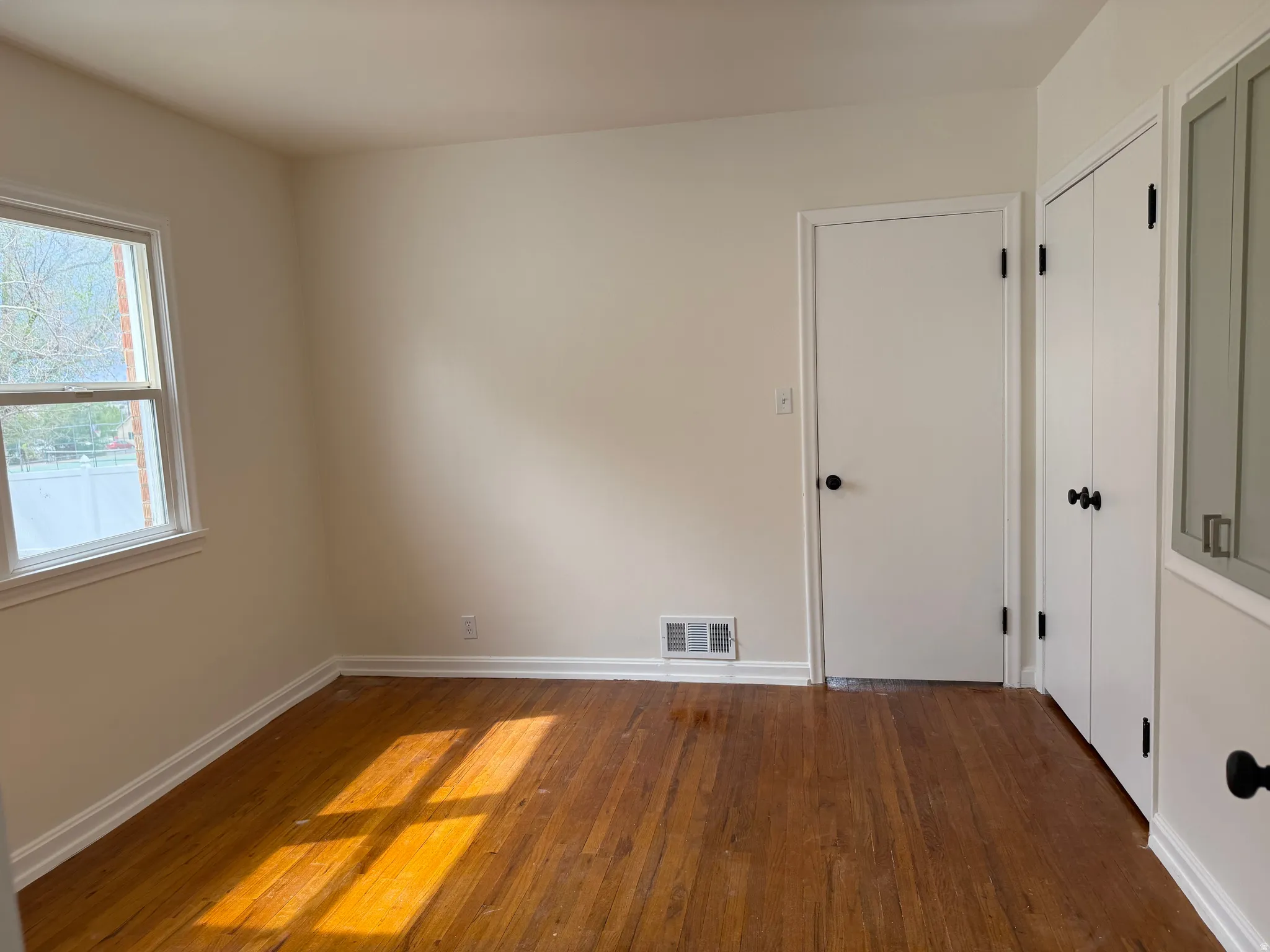 Hardwood flooring extending throughout the room