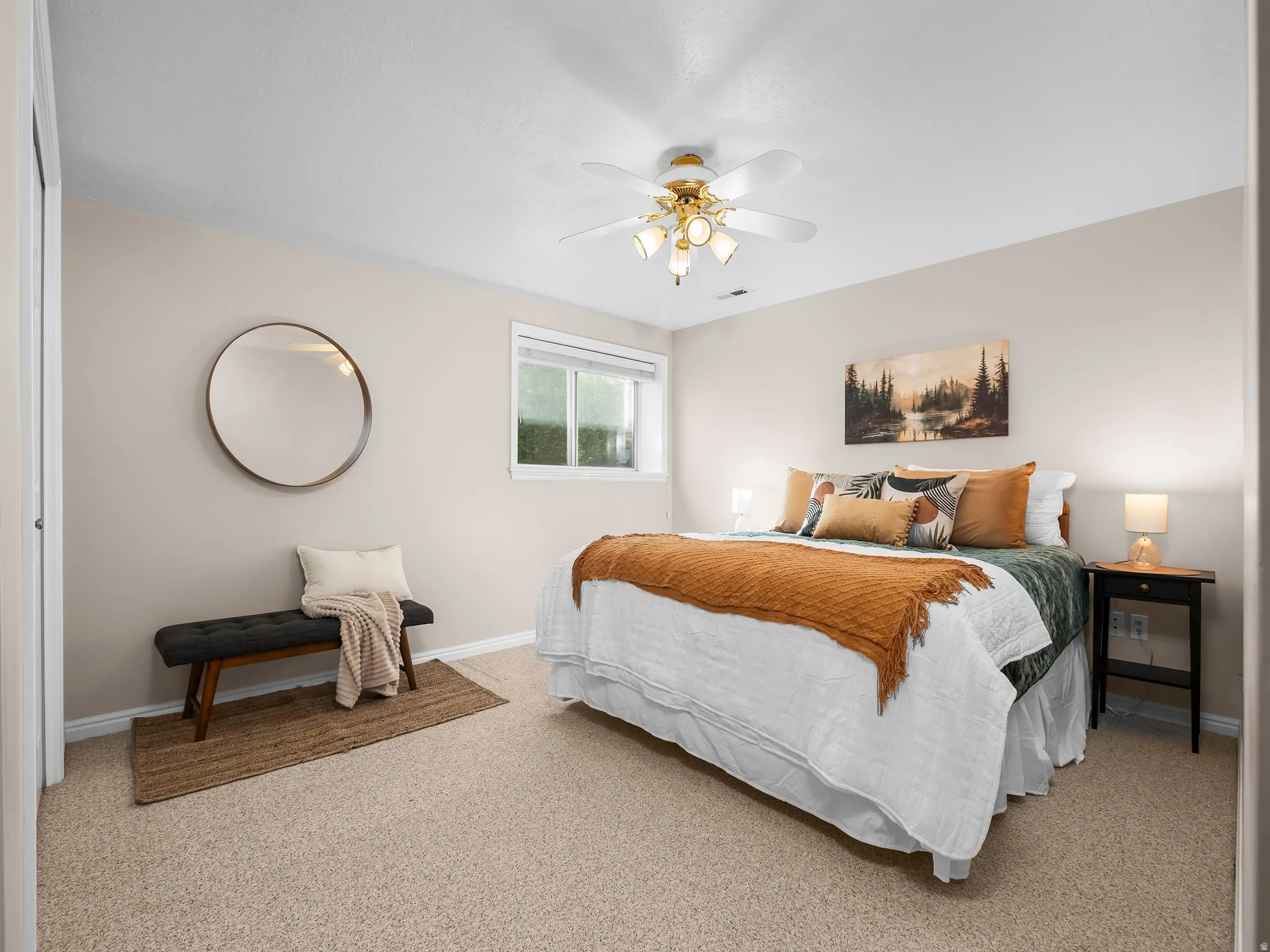 Carpeted bedroom with a window, ceiling fan with lighting, and neutral wall tones