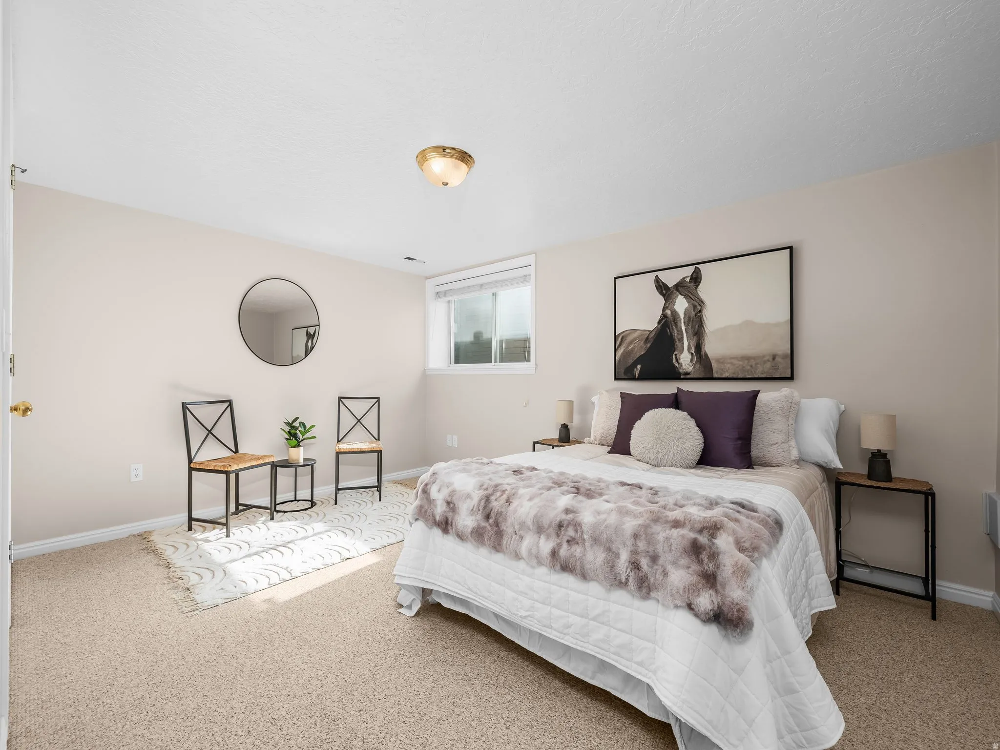 Comfortable room featuring wall-to-wall carpeting, light-toned walls, a single window, and a flush-mount ceiling light fixture