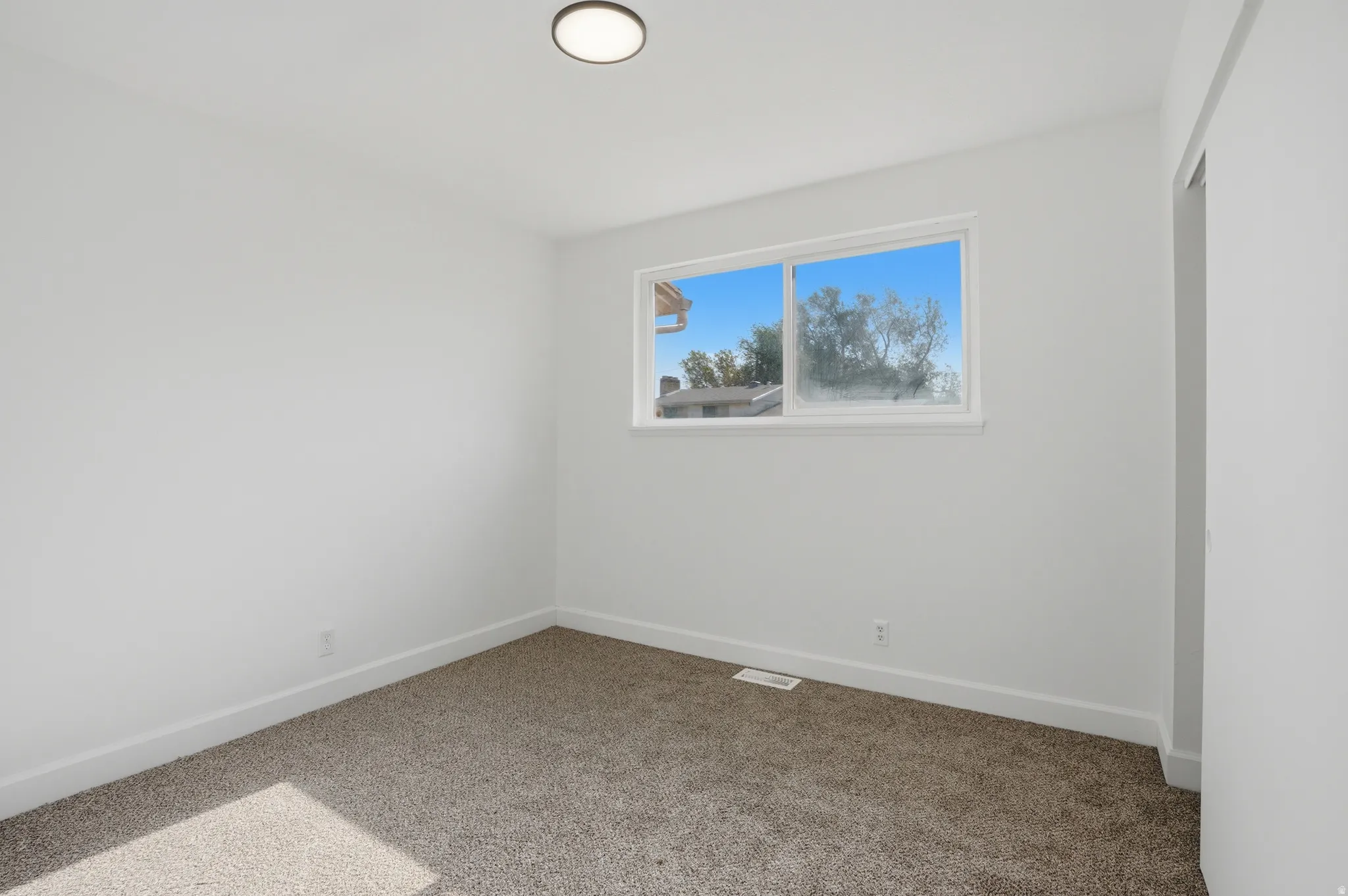 Neutral paint palette with a modern flush-mount ceiling light