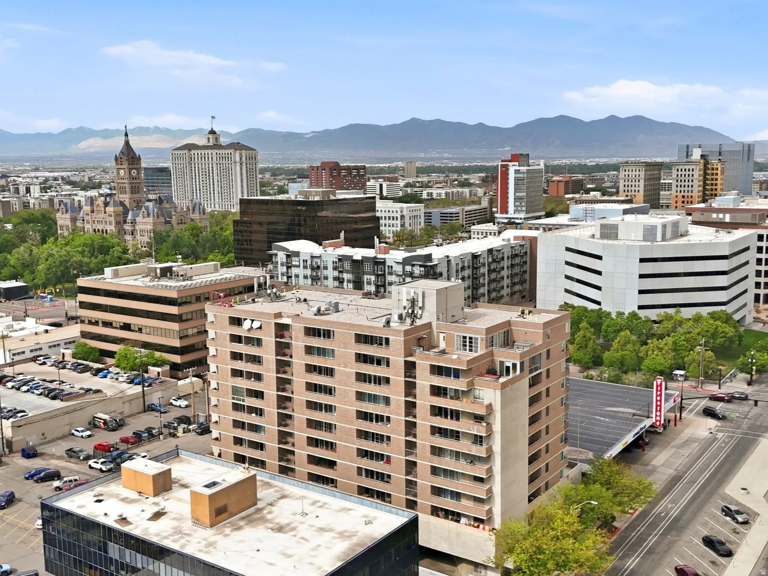 Urban landscape featuring diverse architectural styles, city streets, and distant mountains
