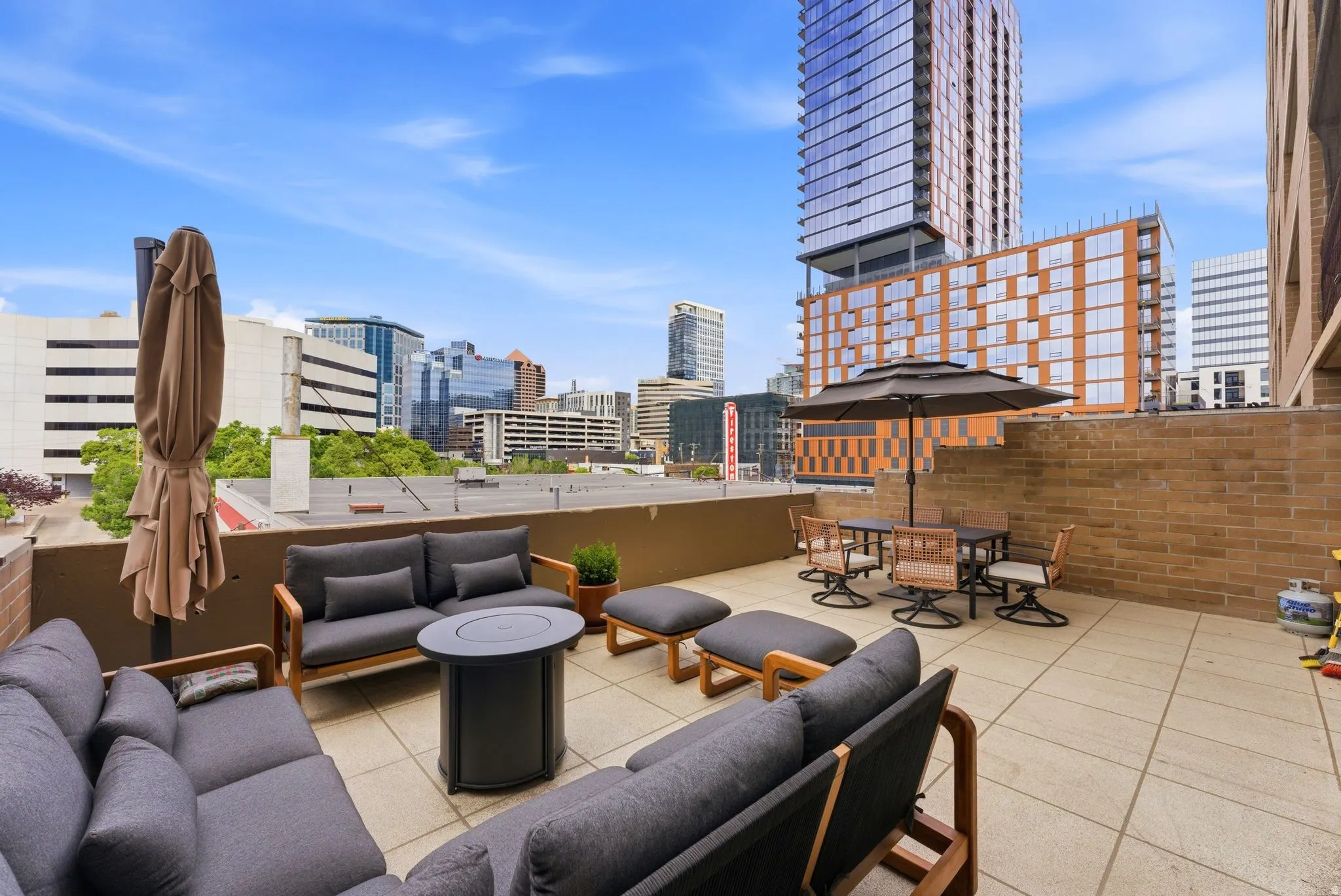 Expansive rooftop terrace with city skyline scenery