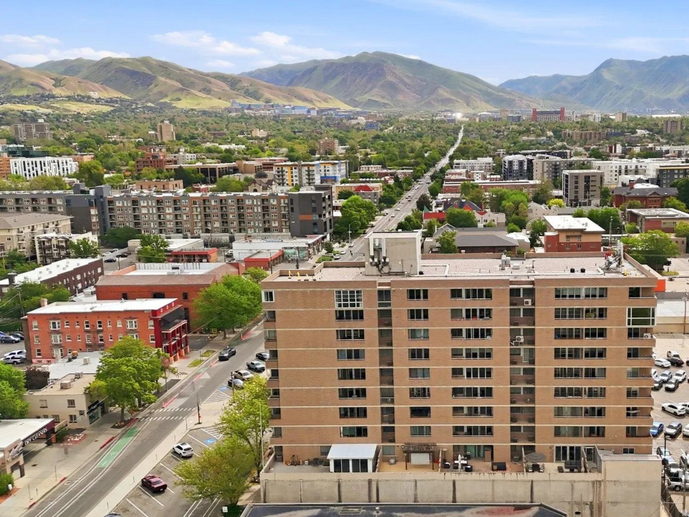 Multi-story building featuring a brown facade, multiple windows, and a flat roofline