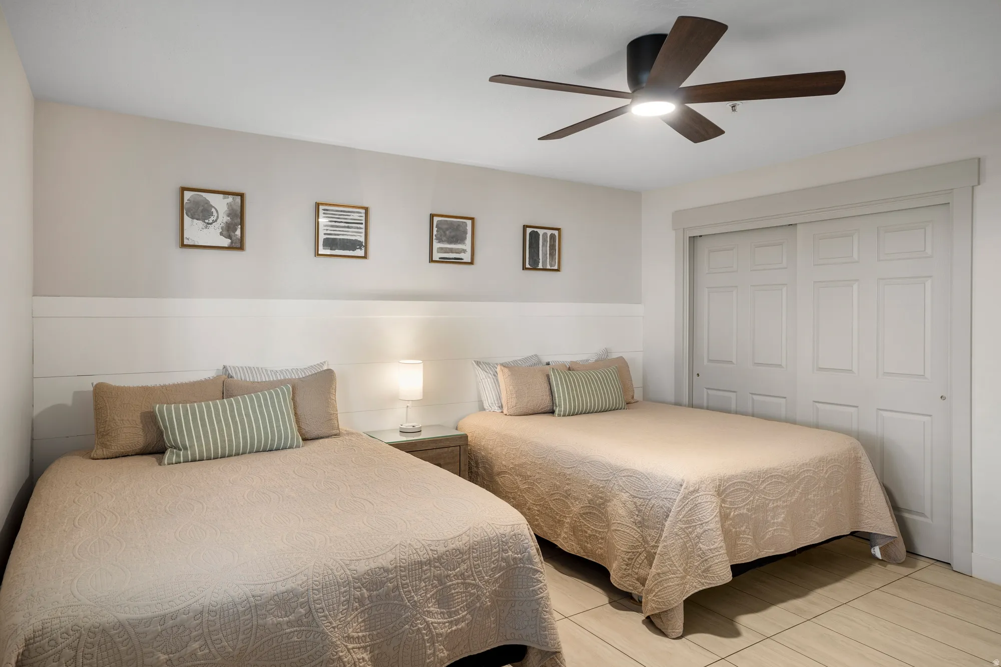 Interior room featuring two beds and light-toned flooring