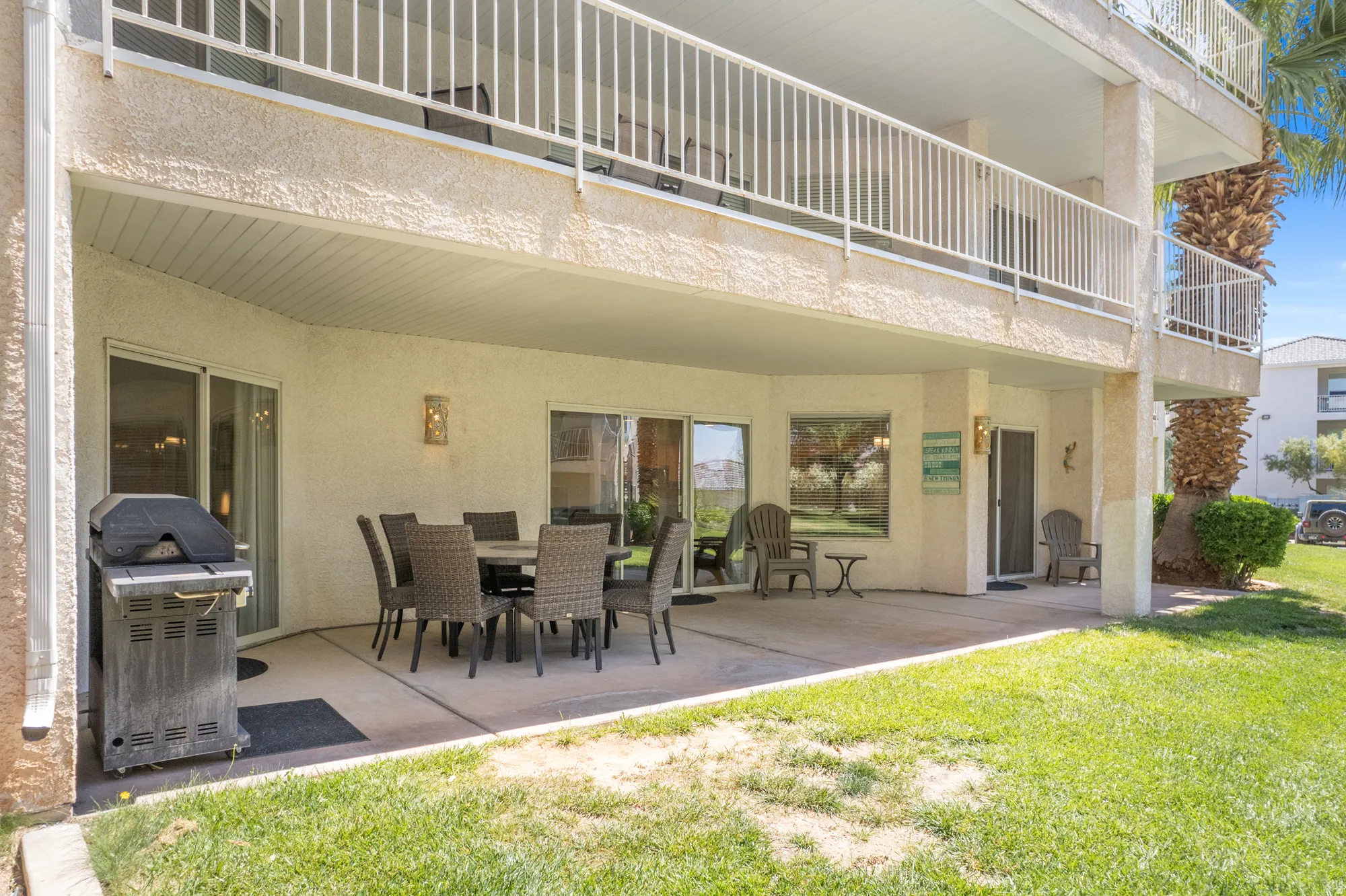 Ground-level patio featuring a concrete surface and direct lawn access
