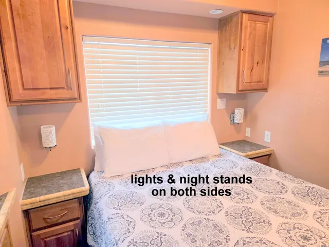 Bedroom featuring a window with blinds, recessed lighting, and built-in cabinetry