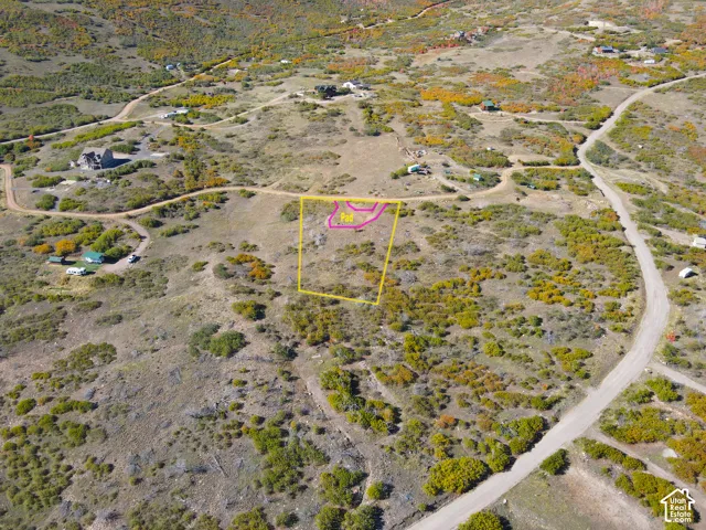 Expansive land parcel featuring natural terrain and visible roads
