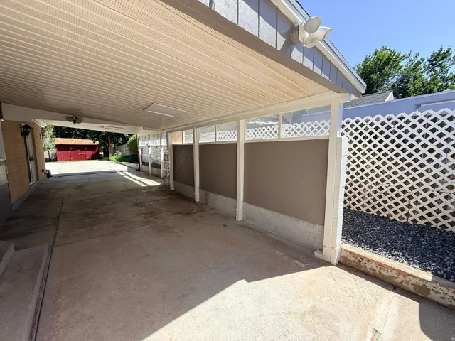 Covered carport featuring a concrete surface