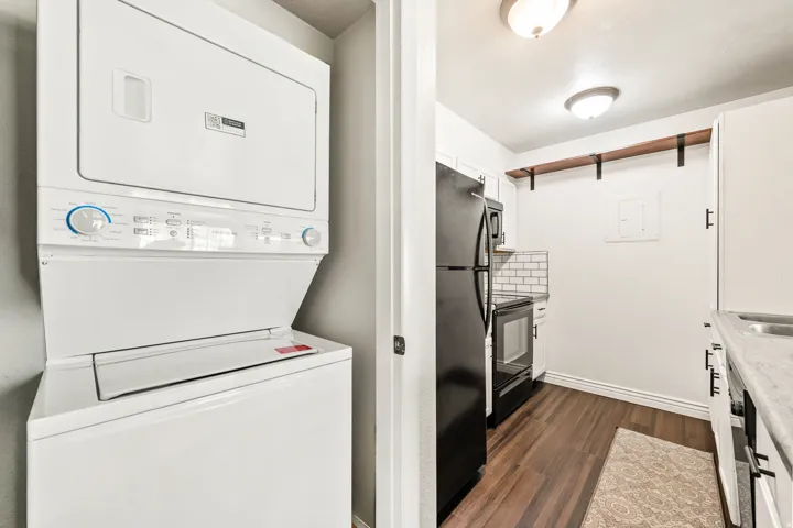 Dedicated laundry area featuring a white stacked washer and dryer