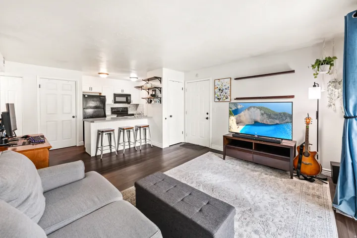 Open concept living area featuring dark wood-finish flooring