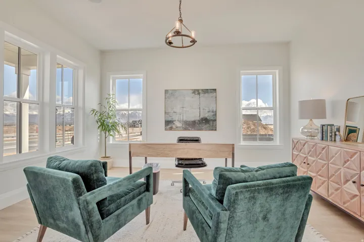 Bright room with multiple windows, light wood-finish flooring, and a contemporary ceiling fixture