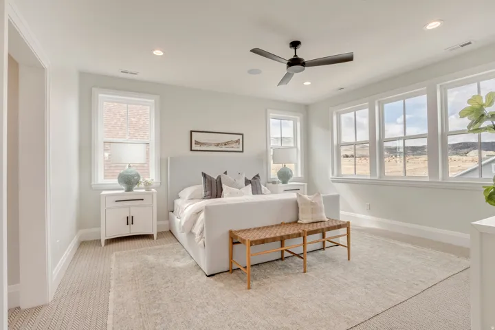 Bright room with multiple windows, recessed lighting, and a ceiling fan