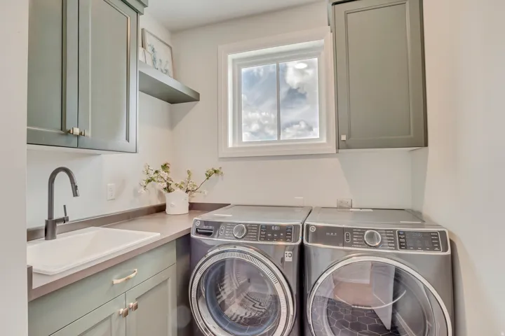 Dedicated utility space featuring sleek cabinetry, a deep sink with a matte black faucet, and a countertop workspace
